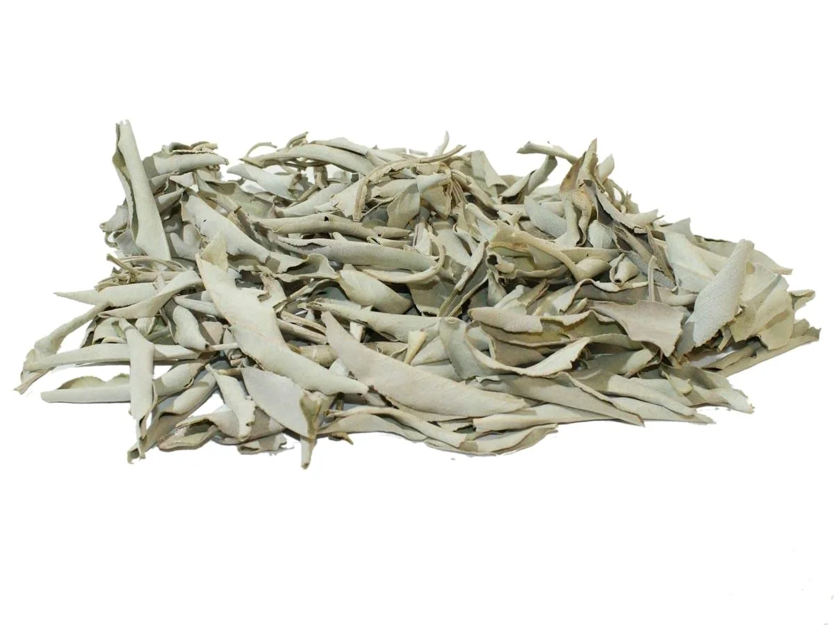 A loose heap of pale gray-green dried white sage leaves on a white background